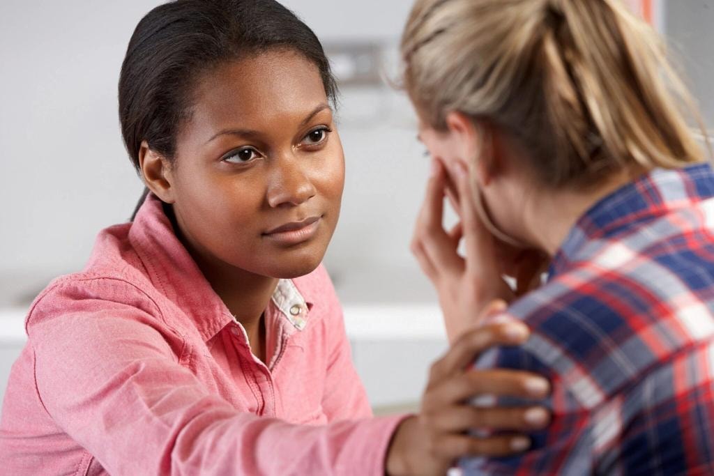 Crisis support counselor comforting a person in distress